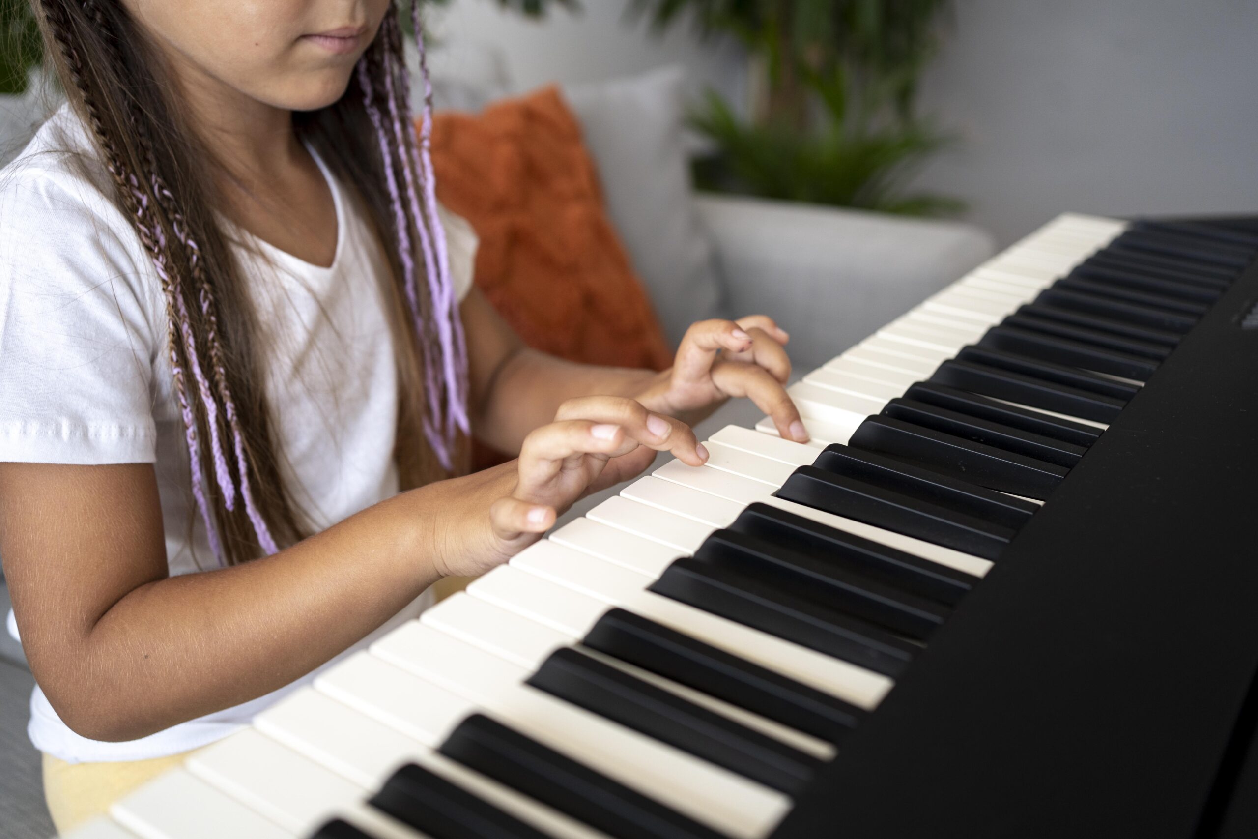 Close up of girl playing piano