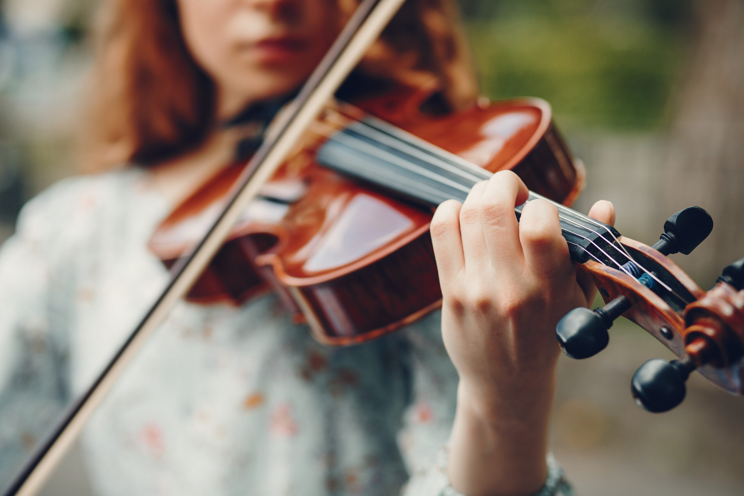 Girl playing violin outside