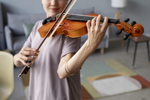 Close up of young girl playing violin